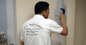 Community painting partnership close up of A.G. Williams Painting Company painter working on wall details