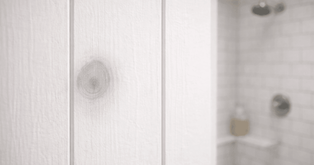Knot bleed stain showing through white painted wood panel