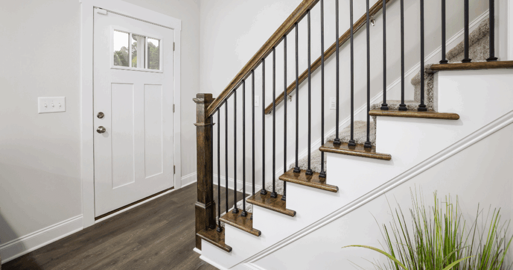 Empty interior room with freshly painted baseboards along a clean white wall. This demonstrates why it's important to paint baseboards if you want to achieve a cohesive look in your interior space.