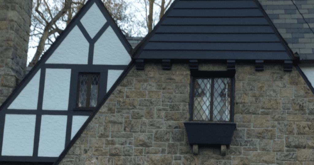 Historic restoration house painting showcasing Tudor style wood trim and stucco with detailed craftsmanship and contrasting finishes