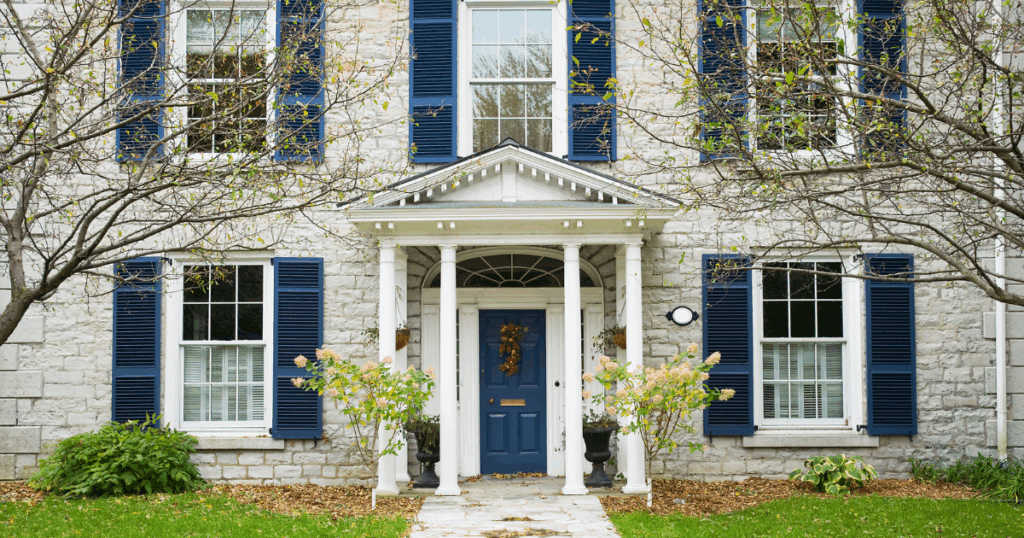 A unified color palette on shutters, trim, and the front door delivers an elegant, cohesive look.