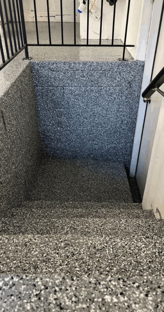Concrete stairs coated with a high-performance 1-day floor coating in a speckled gray finish.