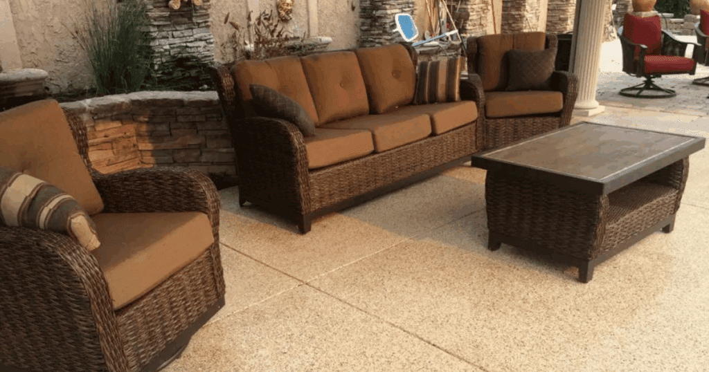 Stylish outdoor patio space with wicker furniture on a professionally finished 1-day floor coatings for concrete surfaces.