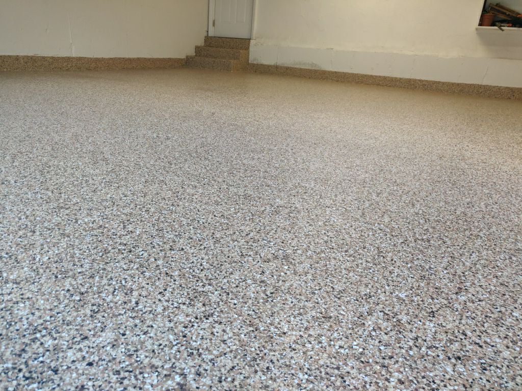 cement garage floor coating with speckled tan, brown and grey texture