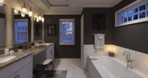 Elegant bathroom with dark charcoal walls in Sherwin-Williams Perle Noir, white trim and cabinetry, and soft lighting for a spa-like atmosphere.