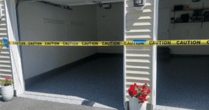 Freshly completed polyaspartic-coated garage floor, cordoned off with caution tape for curing.