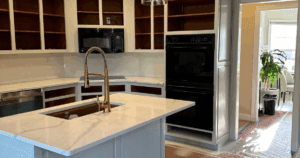 Kitchen cabinets during mid-renovation with doors removed and interiors exposed.