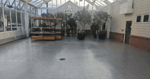 Indoor greenhouse with a sleek, polished epoxy-coated floor.
