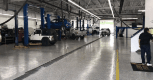 Automotive repair shop with epoxy-coated floors and vehicle lifts.