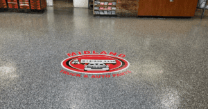 Epoxy-coated floor with custom logo for Midland Truck & Auto Parts.
