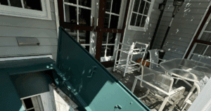 Freshly painted Bilco doors and trim on a shaded residential patio.