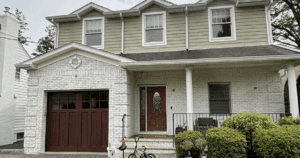 For fall painting inspiration, this is a photo of a home with light taupe siding and white limewash brick exterior with rich wood accents.