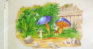 Hand-painted mural of fairies and large mushrooms in a whimsical forest scene.