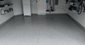 Clean, organized garage with a light gray epoxy floor and wall-mounted storage.