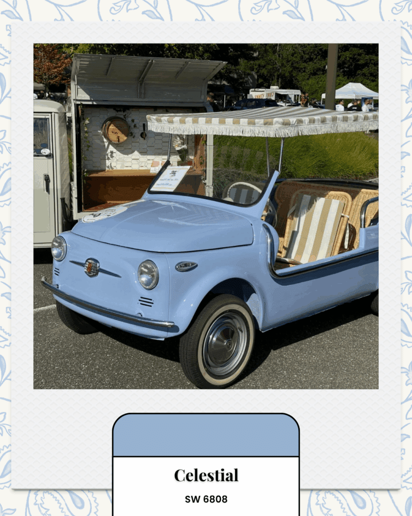 A vintage Fiat Jolly in a soft pastel blue with wicker seats and a striped canopy, displayed at an outdoor car show.