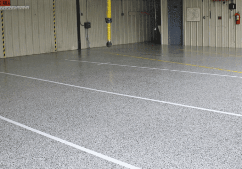 Epoxy-coated commercial garage floor with safety markings